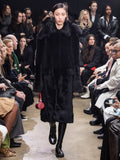 Model Walking in Proenza Schouler Fall Winter 2024 Runway Show Wearing Fiona Coat in Black Sheared Toscana, Silo Bag in Rosewood Nappa, and Park Loafers in Black Slick Nappa