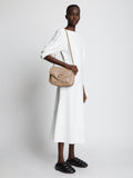 Image of model carrying PS Harris Bag in light taupe