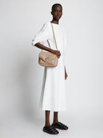 Image of model carrying PS Harris Bag in light taupe