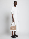 Image of model carrying PS Harris Bag in light taupe