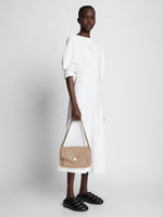 Image of model carrying PS Harris Bag in light taupe