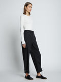 Side full length image of model wearing Cotton Twill Tapered Pants in BLACK