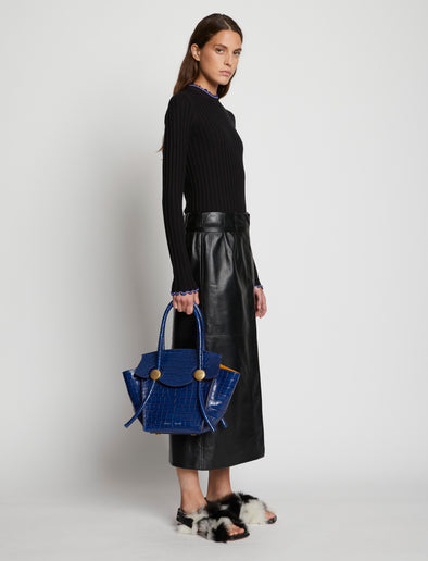 Image of model wearing Embossed Croc Small Pipe Bag in midnight