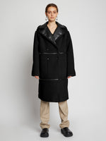 Front image of model wearing Faux Sherpa Coat in black