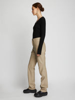 Side full length image of model wearing Leather Straight Pants in TAUPE