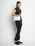 Image of model carrying Raffia PS Harris Bag in optic white