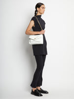 Image of model carrying Raffia PS Harris Bag in optic white