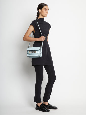 Image of model wearing PS11 Mini Classic Bag in PALE BLUE