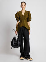 Front full length image of model wearing Plaid Poplin Puff Sleeve Top in OLIVE/BLACK