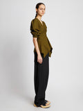 Side full length image of model wearing Plaid Poplin Puff Sleeve Top in OLIVE/BLACK