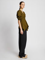 Side full length image of model wearing Plaid Poplin Puff Sleeve Top in OLIVE/BLACK