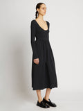 Side full length image of model wearing Rib Knit Long Sleeve Dress in BLACK