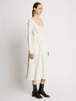 Side full length image of model wearing Rib Knit Long Sleeve Dress in OFF WHITE