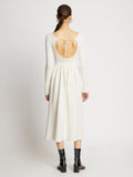 Back full length image of model wearing Rib Knit Long Sleeve Dress in OFF WHITE