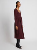 Side full length image of model wearing Rib Knit Long Sleeve Dress in PLUM