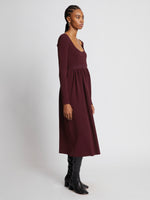 Side full length image of model wearing Rib Knit Long Sleeve Dress in PLUM