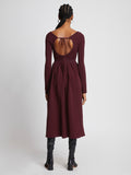 Back full length image of model wearing Rib Knit Long Sleeve Dress in PLUM