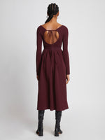 Back full length image of model wearing Rib Knit Long Sleeve Dress in PLUM