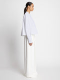 Side full length image of model wearing Eco Poplin Blouse in WHITE