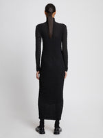 Back full length image of model wearing Shibori Turtleneck Dress in BLACK