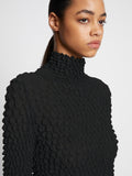 Detail image of model wearing Shibori Turtleneck Top in BLACK