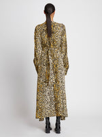 Back full length image of model wearing Printed Leopard Crepe Belted Dress in BUTTER MULTI