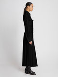 Side full length image of model wearing Pleated Matte Jersey Shirt Dress in BLACK