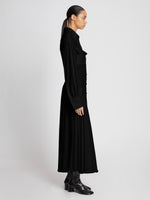 Side full length image of model wearing Pleated Matte Jersey Shirt Dress in BLACK