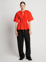 Front full length image of model wearing Poplin Drawstring Blouse in BRIGHT ORANGE