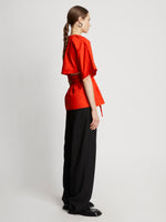 Side full length image of model wearing Poplin Drawstring Blouse in BRIGHT ORANGE