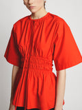 Detail image of model wearing Poplin Drawstring Blouse in BRIGHT ORANGE