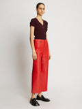 Side full length image of model wearing Leather Culottes in RED