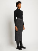 Side full length image of model wearing Lurex Rib Knit Skirt in BLACK/SILVER