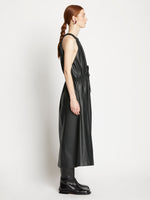 Side full length image of model wearing Faux Leather Drawstring Sleeveless Dress in BLACK