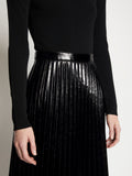 Detail image of model wearing Lacquered Canvas Pleated Midi Skirt in BLACK