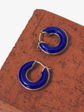 Flat image of mini hoop earrings in cobalt on brick