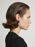 Image of model wearing mini hoop earrings in cobalt