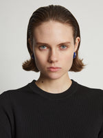 Image of model wearing mini hoop earrings in cobalt