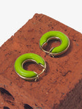 Image of mini hoop earrings in sulphur against brick