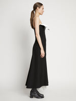 Side full length image of model wearing Matte Viscose Crepe Strapless Dress in BLACK