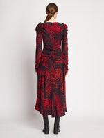 Back full length image of model wearing Painted Spiral Crepe De Chine Cinched Dress in RED MULTI