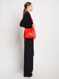 Image of model wearing Drawstring Pouch in POPPY