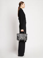 Image of model wearing PS1 leather tote bag in STONE