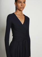 Detail image of model wearing Matte Crepe Wrap Dress in BLACK