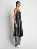 Side full length image of model wearing Drop Waist Faux Leather Dress in BLACK