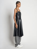 Side full length image of model wearing Drop Waist Faux Leather Dress in BLACK