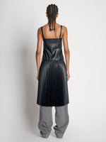 Back full length image of model wearing Drop Waist Faux Leather Dress in BLACK