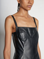 Detail image of model wearing Drop Waist Faux Leather Dress in BLACK