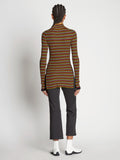 Back full length image of model wearing Stripe Knit Turtleneck in VERMILLION MULTI