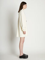 Side full length image of model wearing Cashfeel Cardigan in CREAM